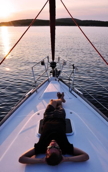 man lying on white boat man lying on white boat