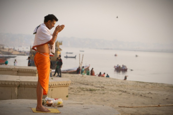 Man Meditating On Seashore Man Meditating On Seashore
