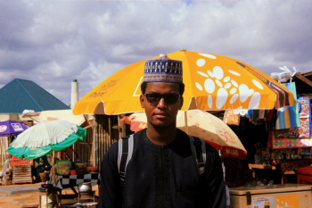 Man Near Parasols and Umbrellas Man Near Parasols and Umbrellas