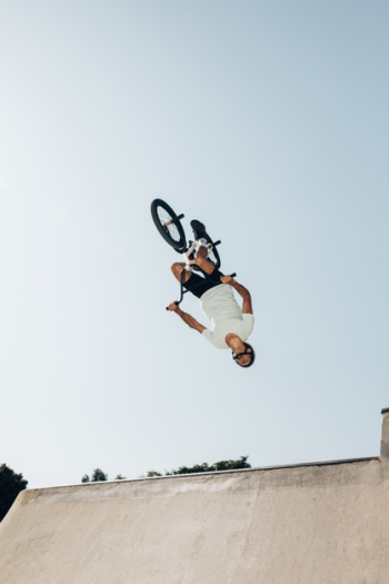 Man on bmx bike performing jump in skatepark Free Photo