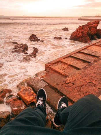 Man Overlooking the Sea during Golden Hour Man Overlooking the Sea during Golden Hour