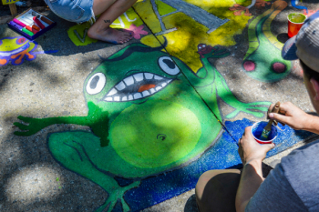 Man Painting Green Frog On Ground Man Painting Green Frog On Ground