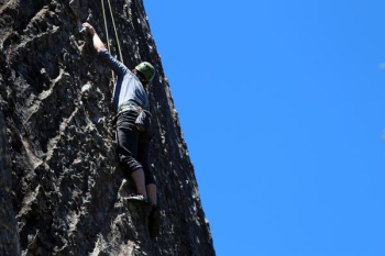 man performing wall climbing under clear sky man performing wall climbing under clear sky