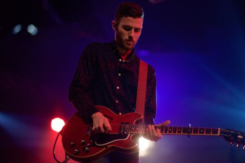 man playing black electric guitar man playing black electric guitar