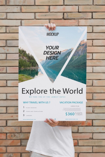 Man presenting poster mockup in front of brick wall Free Psd