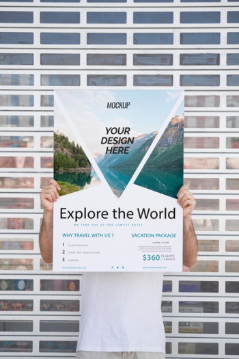 Man presenting poster mockup in front of gate Free Psd