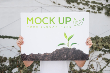 Man presenting poster mockup outdoors Free Psd