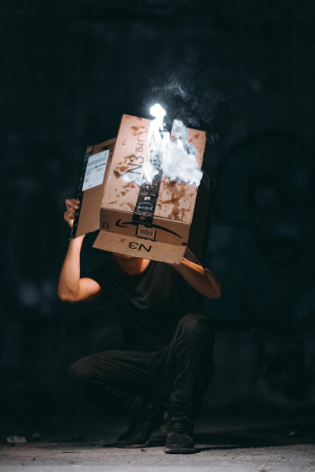 Man Raising Cardboard Box Man Raising Cardboard Box
