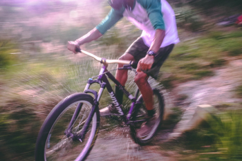 Man Riding Black and White Hardtail Mountain Bike Man Riding Black and White Hardtail Mountain Bike