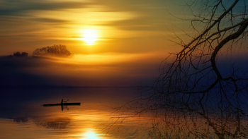 Man Riding Boat during Sunset Man Riding Boat during Sunset