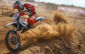 Man Riding Motocross Dirt Bike on Dirt Road Man Riding Motocross Dirt Bike on Dirt Road