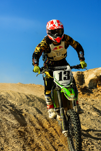 Man Riding Motocross Dirt Bike on Hill Man Riding Motocross Dirt Bike on Hill