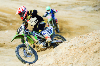 Man Riding Motocross Dirt Bike on Terrain Man Riding Motocross Dirt Bike on Terrain