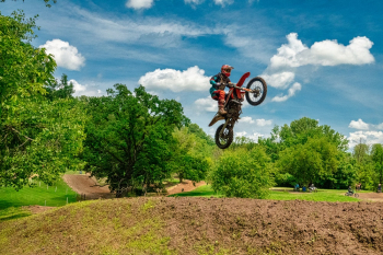 Man Riding on Black and Red Motocross Dirt Bike Man Riding on Black and Red Motocross Dirt Bike
