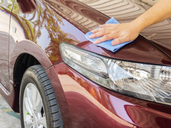 Man's hand is cleaning and waxing the car Man's hand is cleaning and waxing the car