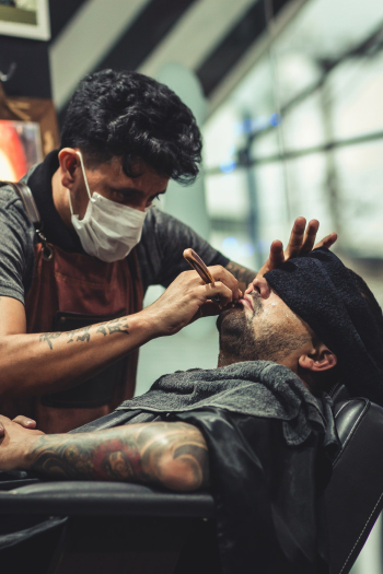 Man Shaving Man&#39;s Beard Using Straight Razor