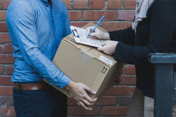 Man Signing For Shipping Box Man Signing For Shipping Box