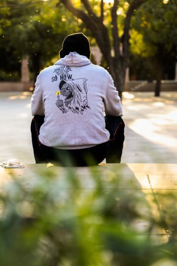 Man Sitting Alone on Pavement