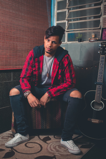 Man Sitting Beside Black Cutaway Acoustic Guitar Man Sitting Beside Black Cutaway Acoustic Guitar