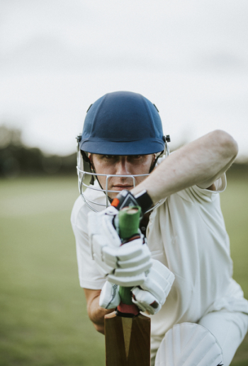 Man Sitting Holding Cricket Bat in Focus Photography Man Sitting Holding Cricket Bat in Focus Photography