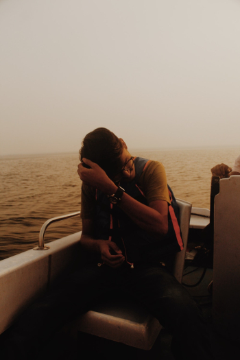 Man Sitting on A Boat Man Sitting on A Boat