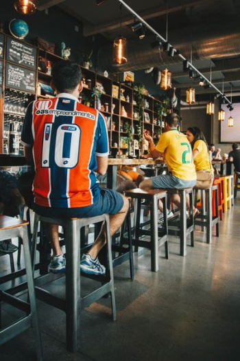 man sitting on bar stools man sitting on bar stools