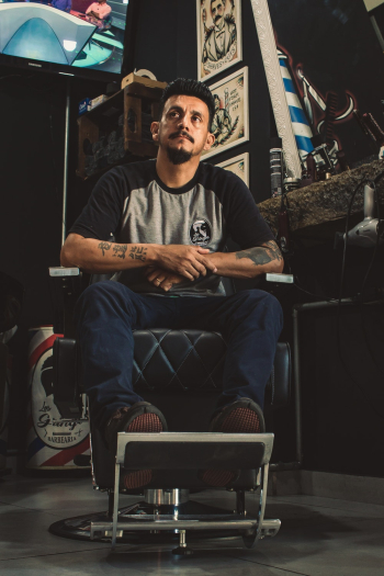 Man Sitting On Barber Chair Man Sitting On Barber Chair