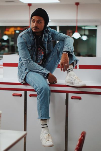 man sitting on cabinet man sitting on cabinet