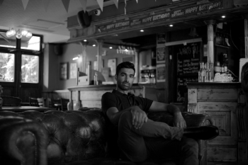 Man Sitting on Leather Sofa Man Sitting on Leather Sofa