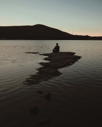 Man Sitting on Sea Rock Man Sitting on Sea Rock