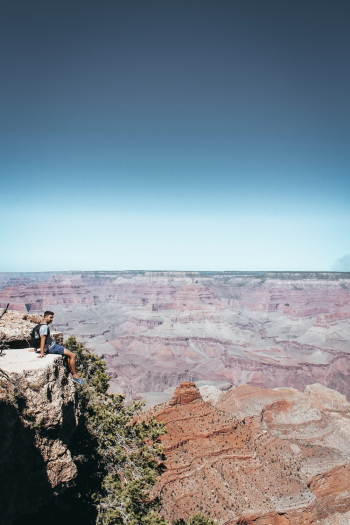 Man Sitting on Top of Rock Mountain Man Sitting on Top of Rock Mountain