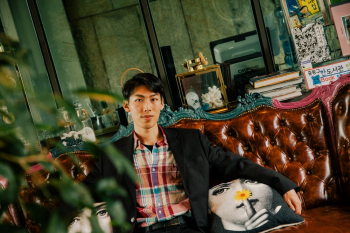 Man Sitting on Tufted Brown Leather Chesterfield Sofa Man Sitting on Tufted Brown Leather Chesterfield Sofa