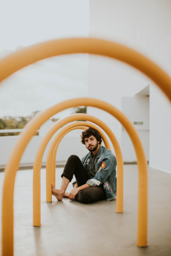 Man Sitting on Yellow Arch Outdoor Man Sitting on Yellow Arch Outdoor
