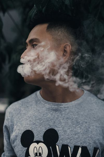 man smoking while looking right man smoking while looking right