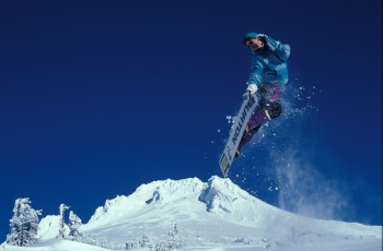 Man Snowboarding during Daytime