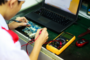 Man Soldering a Circuit Board Man Soldering a Circuit Board