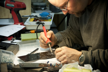 Man Soldering Circuit Board Man Soldering Circuit Board