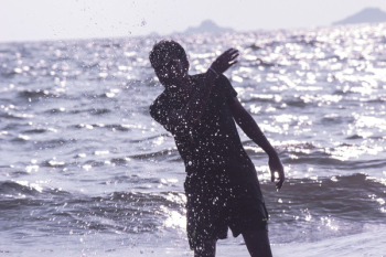 Man Splashing Water on Beach