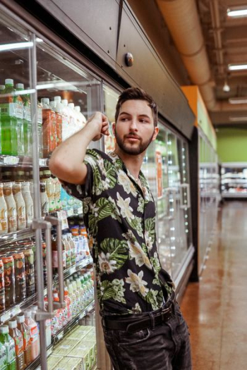 man standing beside commercial refrigerator man standing beside commercial refrigerator
