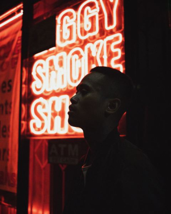 man standing beside neon light man standing beside neon light