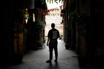 man standing in alley between buildings man standing in alley between buildings