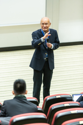 Man Standing in Front of Chairs and People Man Standing in Front of Chairs and People