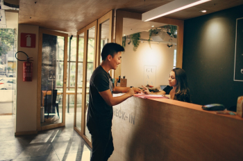 Man Standing in Front of Front Desk Man Standing in Front of Front Desk