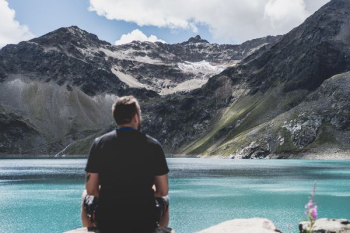 man standing in front of mountain man standing in front of mountain