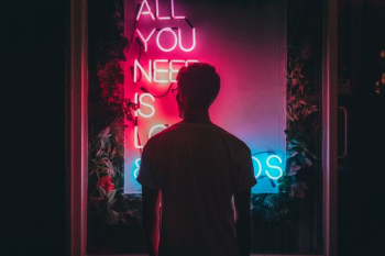 man standing in front of neon lights man standing in front of neon lights