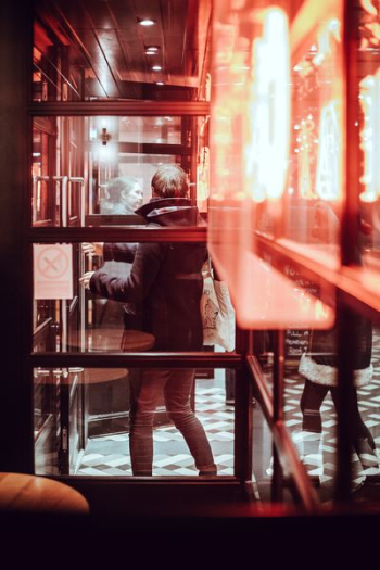man standing near glass wall man standing near glass wall