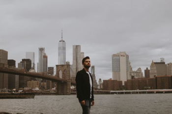 man standing near sea with building background man standing near sea with building background