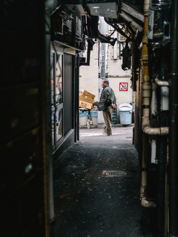 Man Standing Near Trash Can Man Standing Near Trash Can