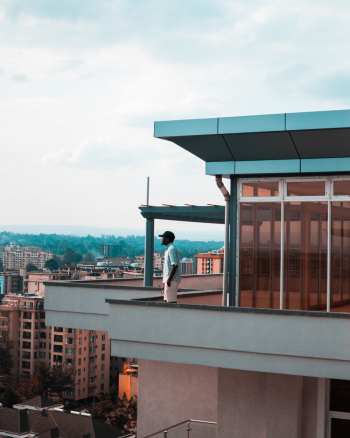 Man Standing on Balcony Man Standing on Balcony