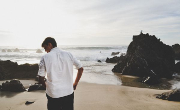 man standing on seashore